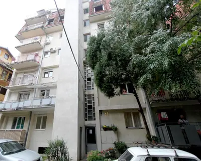 a building with a car parked in front of it at Apartment Lilian in Belgrade