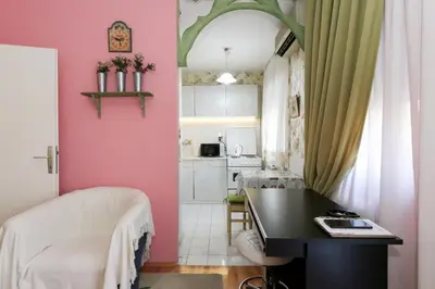 a room with a desk and a pink wall at Apartment Lilian in Belgrade