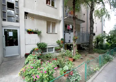a building with a bunch of flowers in front of it at Apartment Lilian in Belgrade