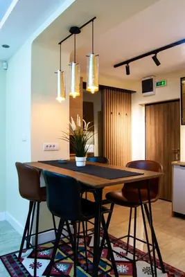 a dining room with a wooden table and chairs at N10 Apartment in Belgrade
