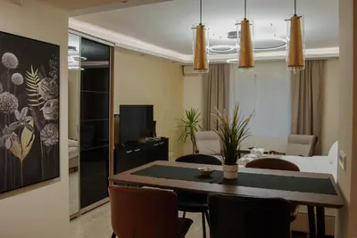 a living room with a dining room table with chairs at N10 Apartment in Belgrade