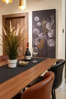 a dining room table with wine glasses and a plant at N10 Apartment in Belgrade