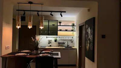 a kitchen with a table with chairs and a dining room at N10 Apartment in Belgrade