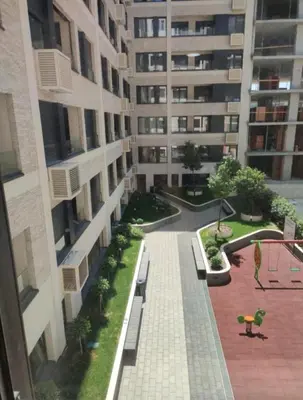 an apartment building with a walkway and benches in a courtyard at West 65 apartment in Belgrade