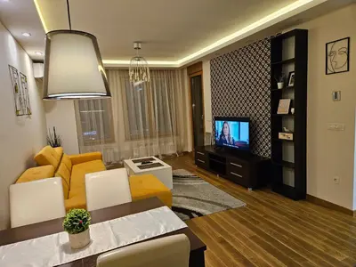 a living room with a couch and a television at West 65 apartment in Belgrade