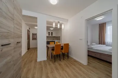 a room with a table and chairs and a bed at M Apartments in Belgrade