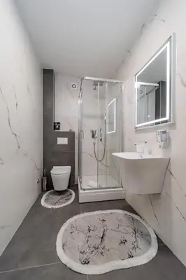 a bathroom with a shower and a sink and a toilet at M Apartments in Belgrade