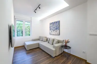 a white living room with a couch and a table at Marshal Dedinje in Belgrade