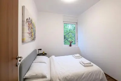 a bedroom with two beds and a window at Marshal Dedinje in Belgrade