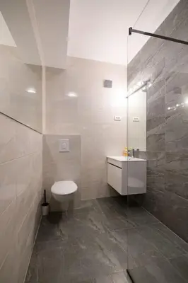 a bathroom with a toilet and a glass shower at Marshal Dedinje in Belgrade