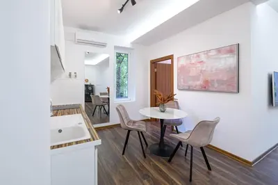 a kitchen and dining room with a table and chairs at Marshal Dedinje in Belgrade