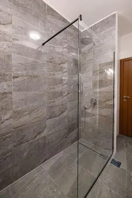 a bathroom with a shower with a glass door at Marshal Dedinje in Belgrade