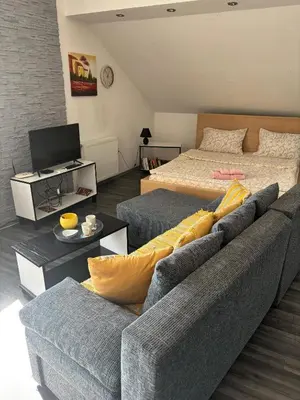 a living room with a couch and a bed at Happy House in Belgrade
