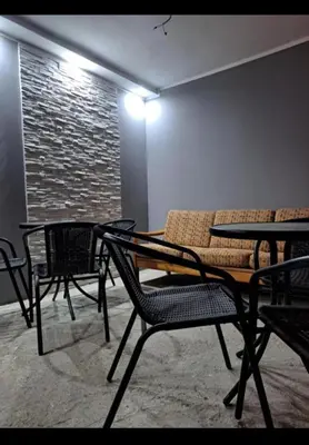 a room with a table and chairs and a couch at Happy House in Belgrade