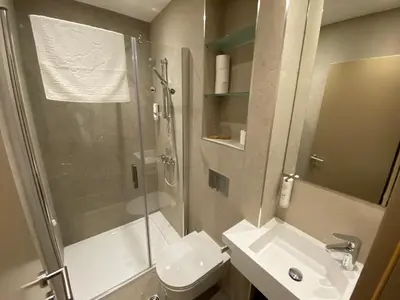 a bathroom with a shower and a toilet and a sink at Konak Stella in Belgrade