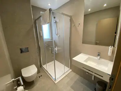 a bathroom with a shower and a toilet and a sink at Konak Stella in Belgrade