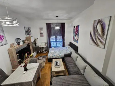 a living room with a couch and a table at Alek Place in Novi Beograd