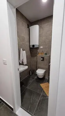 a bathroom with a toilet and a sink at Alek Place in Novi Beograd