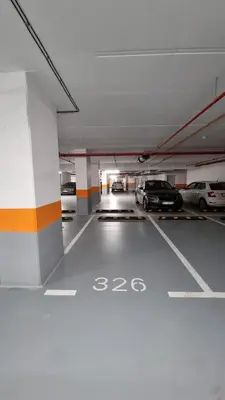 a parking lot with cars parked in a parking garage at Alek Place in Novi Beograd