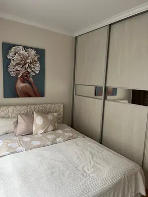 a bedroom with a bed and a painting on the wall at M&M 22 in Belgrade