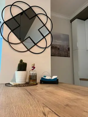 a large orb light fixture hanging over a wooden table at M&M 22 in Belgrade