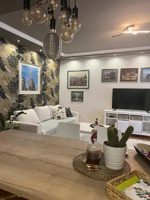 a living room with a couch and a table at M&M 22 in Belgrade