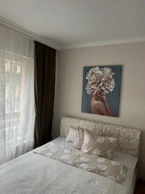 a bedroom with a bed with a flower painting on the wall at M&M 22 in Belgrade