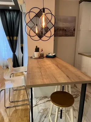 a dining room with a wooden table and chairs at M&M 22 in Belgrade