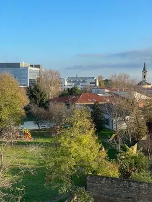 a city with a park with trees and buildings at Perla Lux apartmani in Inđija