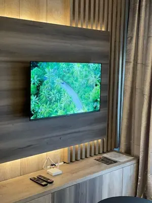 a flat screen tv on a wall in a room at Perla Lux apartmani in Inđija