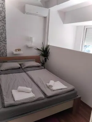 a bedroom with a bed with two towels on it at Apartman 51 in Vračar (historical)