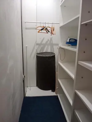 a walk in closet with a black trash can at Apartman 51 in Vračar (historical)