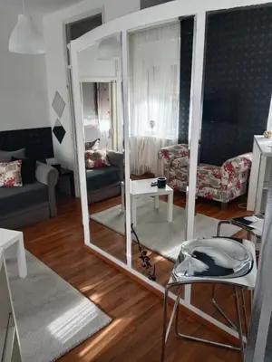 a living room with a mirror and a couch at Apartman 51 in Vračar (historical)