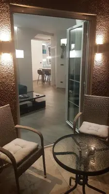 a living room with a glass table and chairs at Apartment Div 2 in Dušanovac (historical)