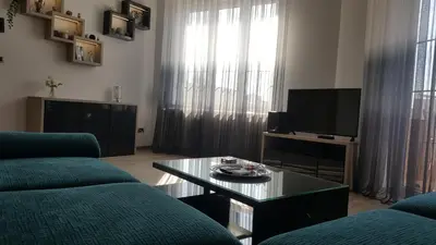 a living room with a couch and a tv at Apartment Div 2 in Dušanovac (historical)