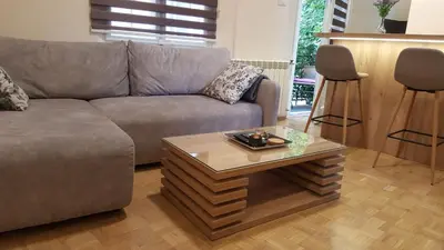a living room with a couch and a coffee table at Apartment Div 3 in Dušanovac (historical)
