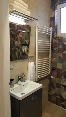 a bathroom with a sink and a mirror and a shower at Apartment Div 3 in Dušanovac (historical)