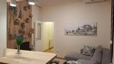 a living room with a couch and a table at Apartment Div 3 in Dušanovac (historical)