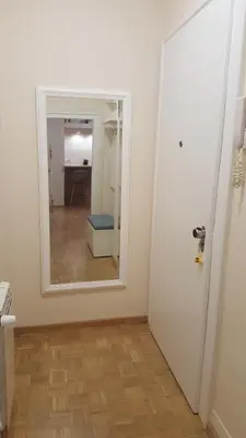 a room with a mirror and a hallway with a door at Apartment Div 3 in Dušanovac (historical)