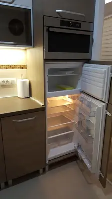 an empty refrigerator with its door open in a kitchen at Apartment Div 1 in Dušanovac (historical)