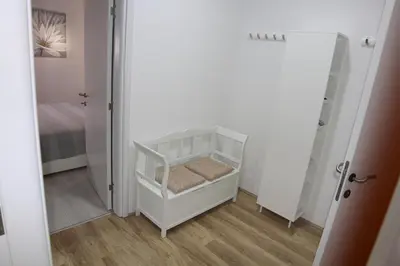 a white crib in a room with a mirror at Apartment Div 1 in Dušanovac (historical)