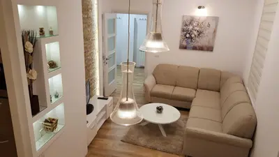 a living room with a couch and a table at Apartment Div 1 in Dušanovac (historical)
