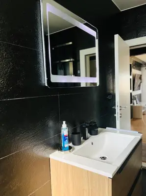a bathroom with a white sink and a mirror at Apartment Black Diamond - Vracar, Belgrade in Belgrade