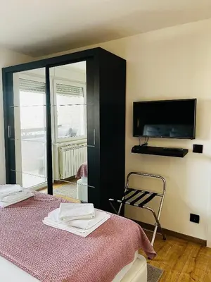 a bedroom with a bed and a flat screen tv at Apartment Black Diamond - Vracar, Belgrade in Belgrade