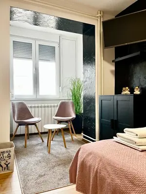 a bedroom with two chairs and a bed at Apartment Black Diamond - Vracar, Belgrade in Belgrade