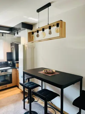 a black table and chairs in a kitchen at Apartment Black Diamond - Vracar, Belgrade in Belgrade