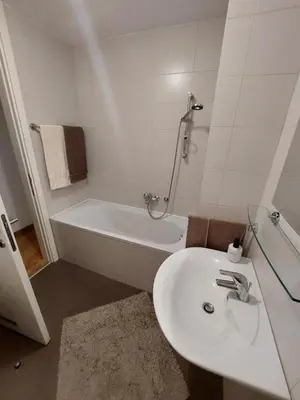 a bathroom with a sink and a bath tub at Apartment Belville, Suncokret 26 in Novi Beograd