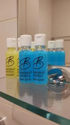 a group of bottles of detergent sitting on a counter at Apartment Belville, Suncokret 26 in Novi Beograd
