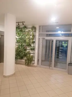 an empty room with a large glass door in a building at Apartment Belville, Suncokret 26 in Novi Beograd