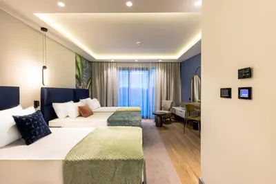a hotel room with two beds and a couch at Calisi Hotel in Belgrade